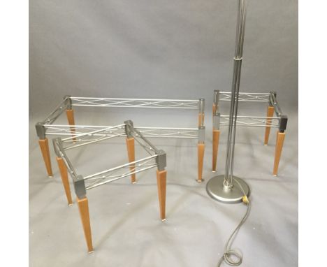 A modern suite of three glass topped tables, together with a five branch standard lamp