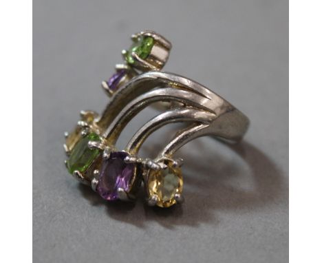 A silver peridot and amethyst ring