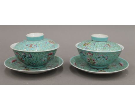 A pair of Chinese porcelain covered bowls and saucers