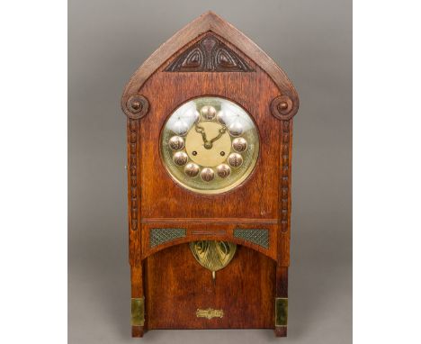 A Continental Arts &amp; Crafts oak cased wall clock by Gustav Becker, the 8 1/2 inch brass and copper dial with Roman numera