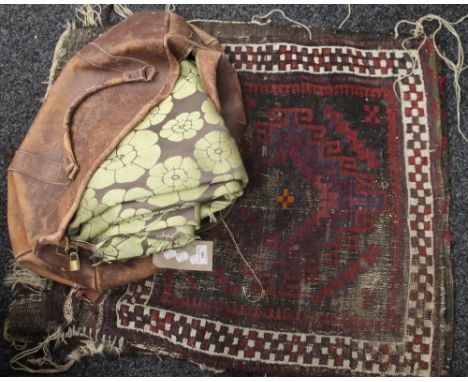 A Caucasian saddle bag rug, together with a quantity of floral material and a vintage leather weekend bag