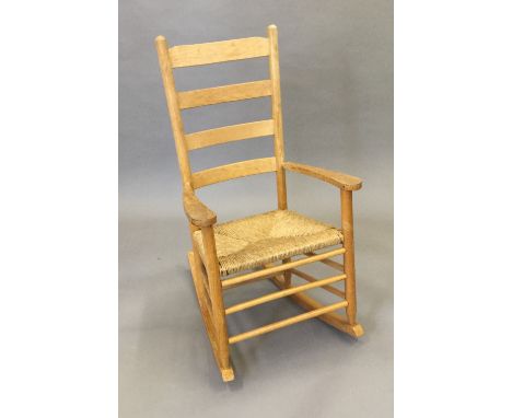 A modern rush seated ladder back rocking chair