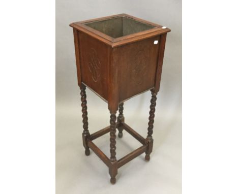 An early 20th century oak barley twist planter