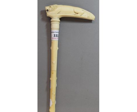 A 19th century carved ivory walking stick, the handle formed as a lion