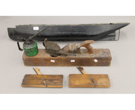 A vintage saw, planes, oil cans and a model boat's hull