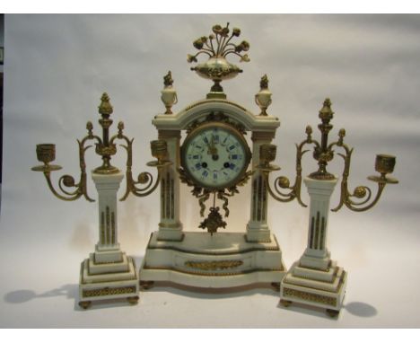 A late 19th Century French three piece clock garniture; with black Roman numerals and subsidiary Arabic minutes to the 10cm d