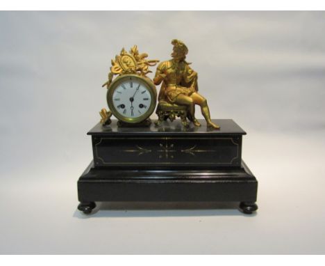 A late Victorian figural mantel clock, with black Roman numerals to the white enamelled face, the movement striking on a bell