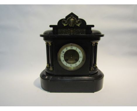 A Victorian black slate mantel clock, with black Arabic numerals to the cream chapter ring, the movement striking on a gong; 