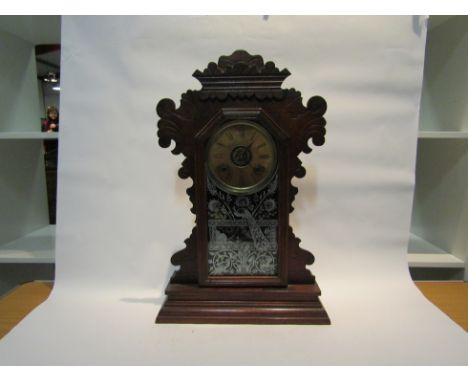 A late 19th Century American alarm mantel clock by the Ansonia Clock Co, with black Roman numerals to the cream face, the key