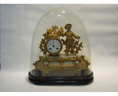 A late 19th century French figural mantell clock, with black Roman numerals to the white enamelled face, the movement strikin