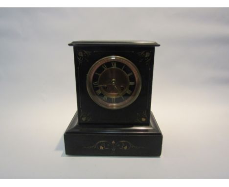 A late Victorian black slate mantel clock, with gilded incised Roman numerals around a brass and copper centre, the 8-day mov
