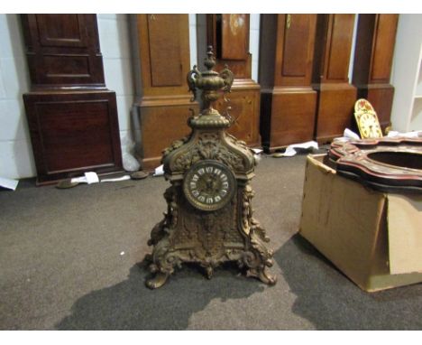 A 19th Century French ornate gilded mantel clock, with blue Roman numerals to the white chapter plaques on the decorative fac
