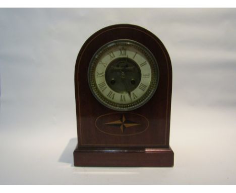 A late Victorian/ Edwardian mantel clock, with gilded Roman numerals incised into the cream painted chapter ring around a vis