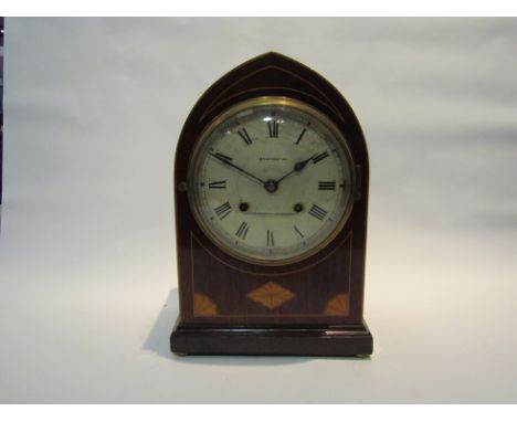 A late Victorian mantel clock with black Roman numerals to the silvered face, named "Bravington, Kings Cross &amp; Ludgate Hi