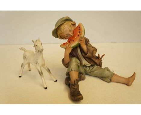 Ceramic figure of a boy together with a Beswick foal 