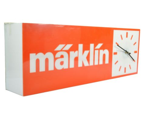 A large Plastic wall mountable Marklin Illuminated Shop Display Sign with clock. Comes with wired three pin plug. Mounting po