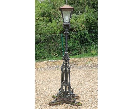 A Victorian cast iron street lamp,the four glass lantern top over a column and scrolling quadripartite base,86cm wide210cm hi