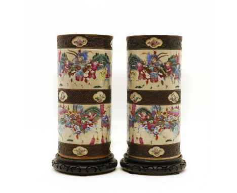 A pair of Chinese famille rose vases,late 19th century, of cylindrical form, decorated with scenes of warriors in a landscape