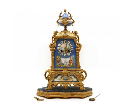 A gilt spelter and porcelain mantel clock and stand,late 19th century, French, with Sèvres style panels and urn, the two-trai