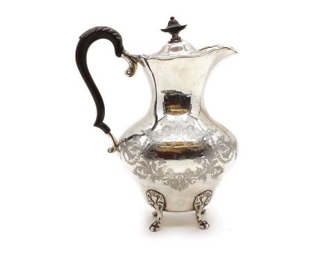 A silver hot water jug,by R F Mosley &amp; Co, Sheffield 1909, the bulbous body engraved with foliate decoration, on four paw