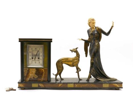 An Art Deco ivory mounted figural spelter clock, by Menneville, modelled as a woman with a greyhound, the onyx mounted clock 