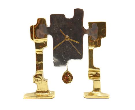 A David Marshall aluminium and brass timepiece,with two stepped supports, complete with pendulum,25cm wide26cm highCondition 