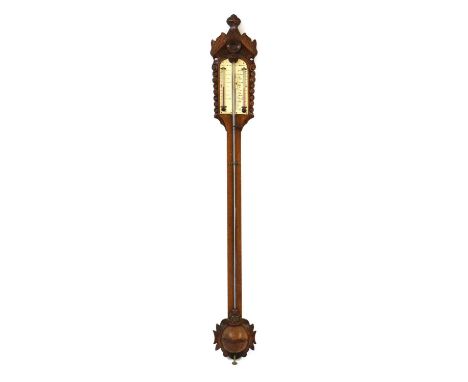 A Victorian oak stick barometer,with a carved crest and ivory register engraved 'Taylor & Son, Sittingbourne', over a turned 