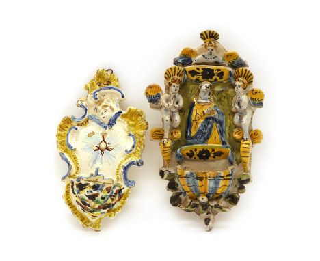 An Italian Maiolica wall font,late 19th to early 20th century, relief decorated with the Madonna flanked by three winged putt