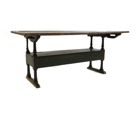 A oak monk's bench,18th century, with cleated plank top above a box seat,177cm wide,80cm deep76.5cm high folded flatCondition