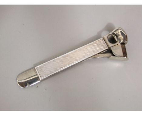 A silver cigar cutter with silver mounted grip and engine turned decoration