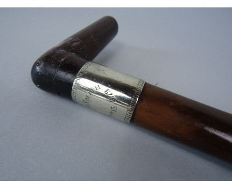 Substantial naturalistically nobbly walking stick with carved rosewood handle and white metal collar