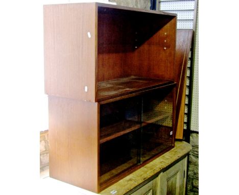 A teak wood Ladderax unit with two ladder supports enclosing two teakwood fittings, one with sliding glass doors, overall wid