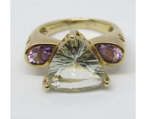 9ct dress ring set with a trillion cut topaz flanked by a pair of pear cut amethysts, with decorative pierced detail to shoul