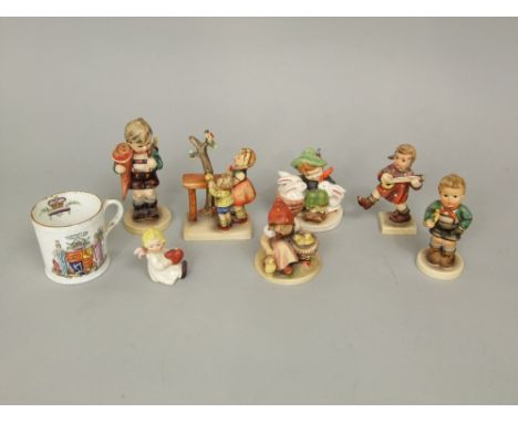 A collection of Hummel and Hummel style figure groups including a boy musician, etc, together with a 1902 coronation mug, etc