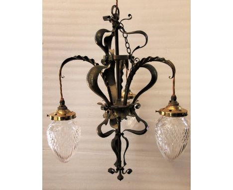 A good quality Art Nouveau/crafts brass hanging ceiling light, the central pole/stem supporting whip lash scrolling planished