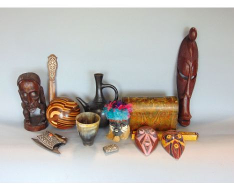 A box of ethnic and tribal wares to include a horn beaker, various masks, a treen bull, white metal and cabochon a steel fire