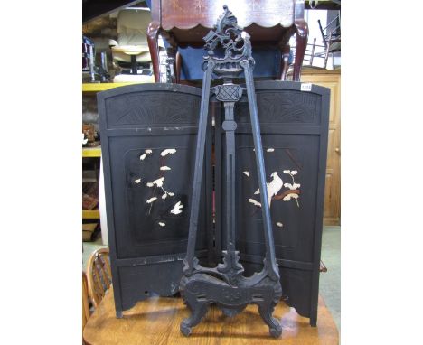 A carved hardwood decorative studio easel with pierced detail and an ebonised two fold Japanese fire screen