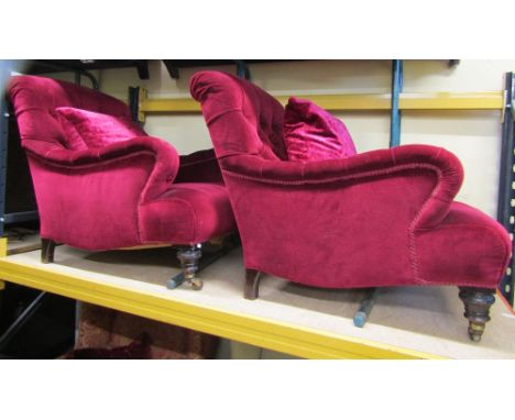 A pair of mid 19th century button back drawing room chairs in the Howard style with turned forelegs, chamfered backs and supp