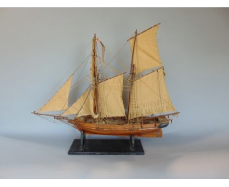 A scratch built model of a two mast sailing vessel upon an ebonised stand, 70 cm long