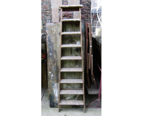 A vintage Pioneer pine framed folding step ladder with cast iron hinges and graduated treads (to be sold for display purposes
