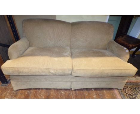 A good quality contemporary two/three seat sofa of traditional form with light tan coloured fabric upholstery, on turned maho