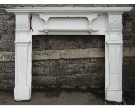 A reclaimed Edwardian fire surround with architectural split moulded and fluted columns and carved Art Nouveau style foliated