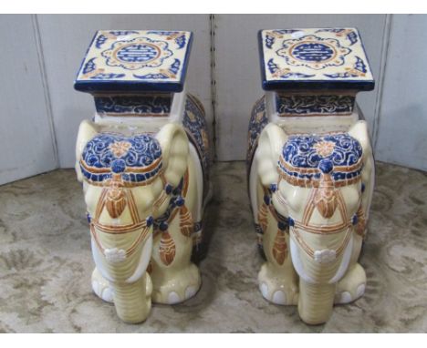 A pair of Chinese ceramic garden seats in the form of elephants, saddled with howdah's and a small mahogany and glass wall ca