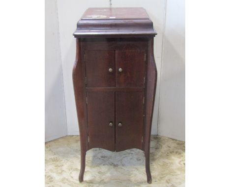 An Edwardian floorstanding gramophone cabinet, The Ptonia, with enclosed speaker and record storage rack and a piano stool