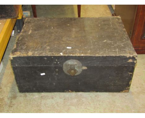 A plywood trunk containing an unsorted collection of hand tools to include planes, scrapers, saws, etc