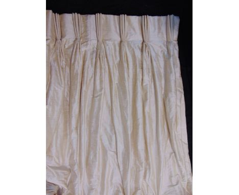 One pair of full length curtains in ivory dupion silk, lined and interlined with triple pleat heading, length 2.3 m, fixed to