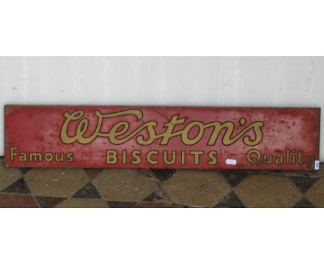 A vintage enamel sign of rectangular form advertising Weston's Famous Quality Biscuits, gold coloured lettering on a red grou