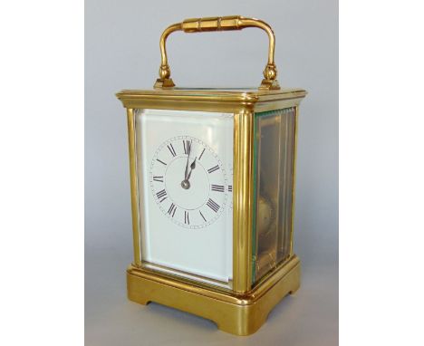 A good large brass cased carriage clock, the enamelled dial with Roman numerals, striking on a gong, 14 cm high