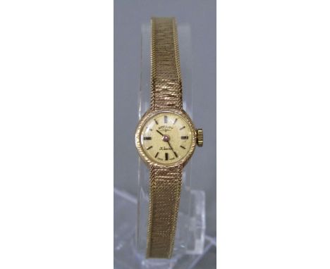 Ladies 9ct Rotary 21 jewel dress watch, with textured champagne dial and baton markers upon a mesh textured strap, 14.3g