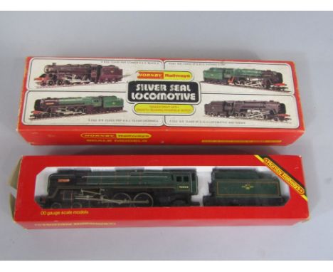 A Hornby 0 gauge R.552 B.R.Class 7P 6F 4-6-2 Oliver Cromwell steam engine and tender with box, together with an R.063 B.R. lo